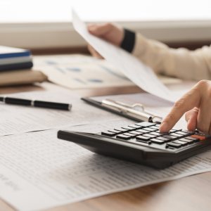 Person calculating expenses with documents