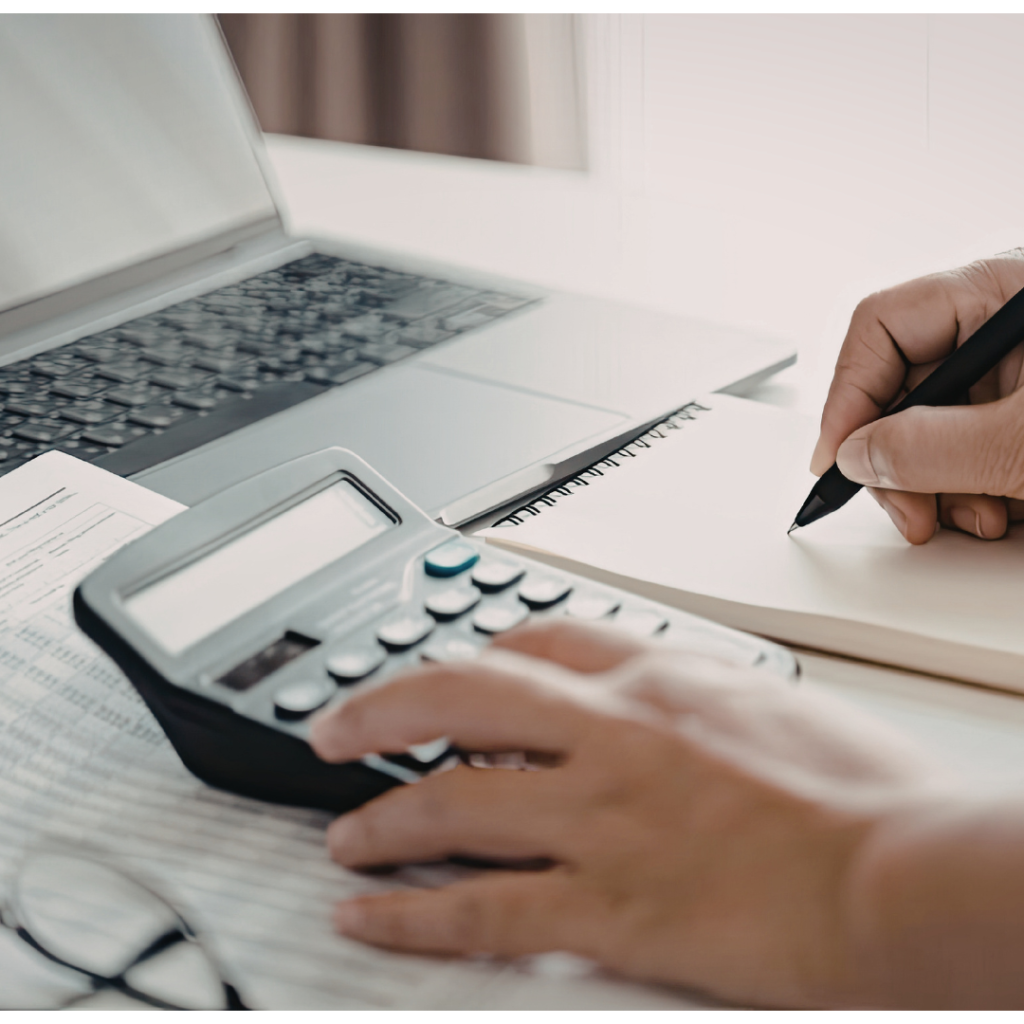 Calculator, laptop, notes, to start up a loan repayment calendar