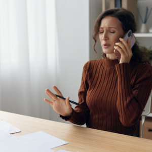 woman on the phone talking to a person thinking it's debt collector scams.