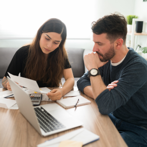 Couple reviewing bills at a table.