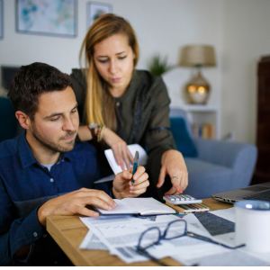 Couple managing finances at home.