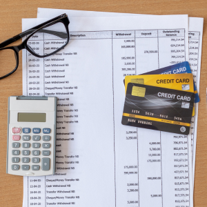 Calculator, glasses, bank statements, credit cards