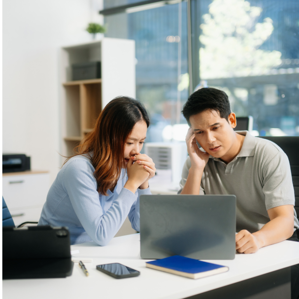 distraught couple looking at a computer for recover from financial mistakes